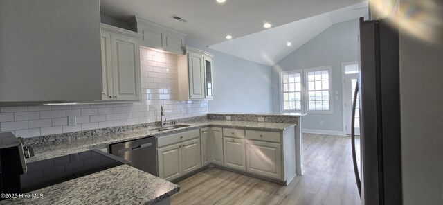 doorway to outside with lofted ceiling, light hardwood / wood-style floors, and french doors