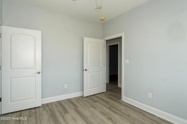 doorway to outside featuring hardwood / wood-style flooring and ceiling fan