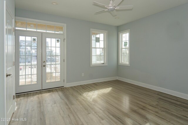 interior space with ceiling fan and wood-type flooring