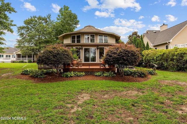 front of property featuring a wooden deck and a front lawn