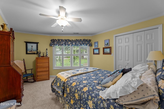 bedroom with visible vents, a ceiling fan, ornamental molding, carpet flooring, and a closet