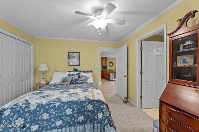 bedroom featuring light tile patterned floors, ceiling fan, a closet, and crown molding