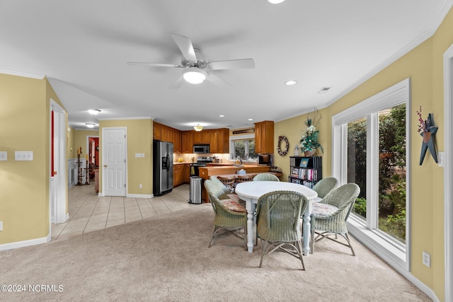 dining area featuring ornamental molding, light carpet, visible vents, and light tile patterned flooring