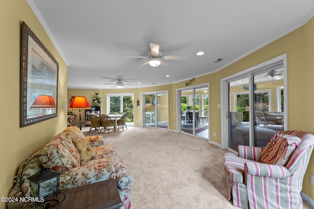 carpeted living area featuring baseboards, recessed lighting, visible vents, and crown molding