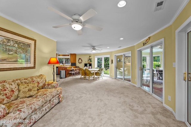 living area with recessed lighting, light colored carpet, crown molding, and visible vents