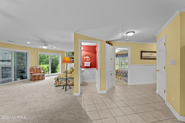 interior space with ornamental molding, plenty of natural light, and ceiling fan