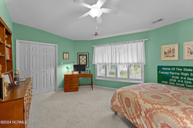 carpeted bedroom featuring a closet and ceiling fan