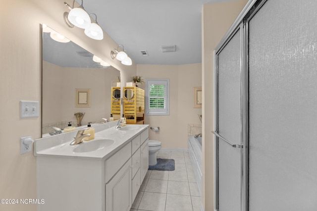 bathroom featuring double sink vanity, toilet, and tile patterned floors