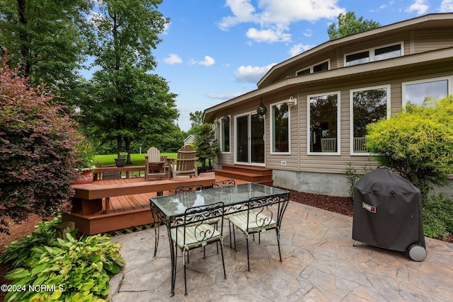 view of patio with outdoor dining space, a deck, area for grilling, and entry steps