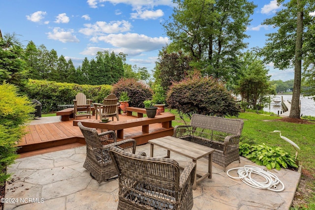 view of patio / terrace with a deck with water view