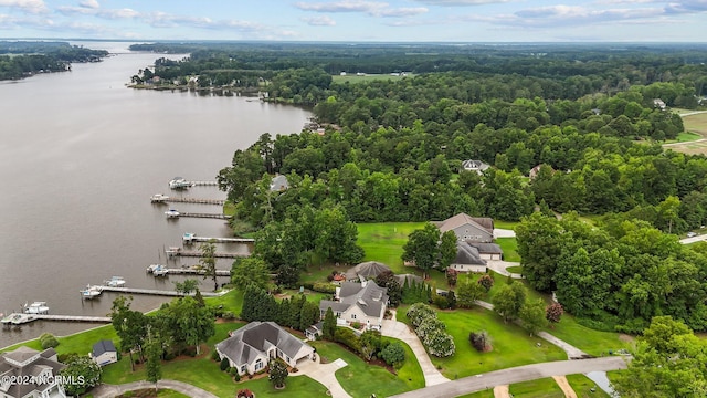 aerial view with a water view and a wooded view