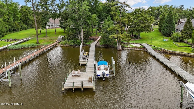 dock area with a water view and a yard