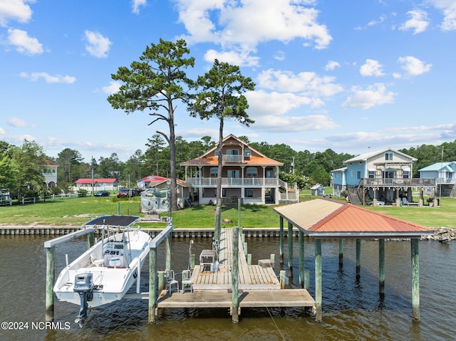 dock area featuring a balcony, a water view, and a yard