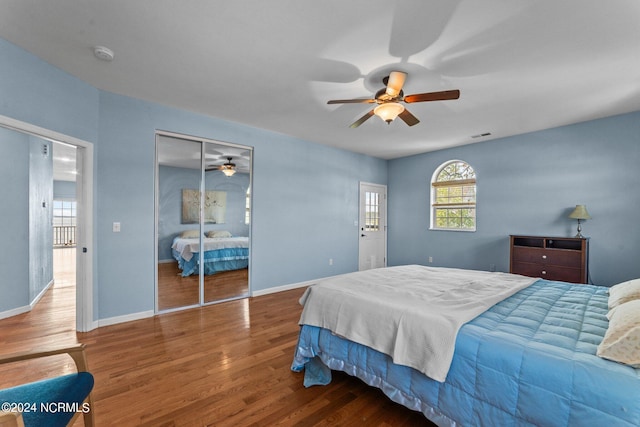 bedroom with ceiling fan, hardwood / wood-style floors, and a closet