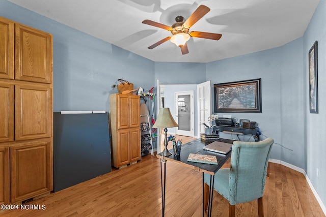 office area featuring light wood-type flooring, ceiling fan, and baseboards