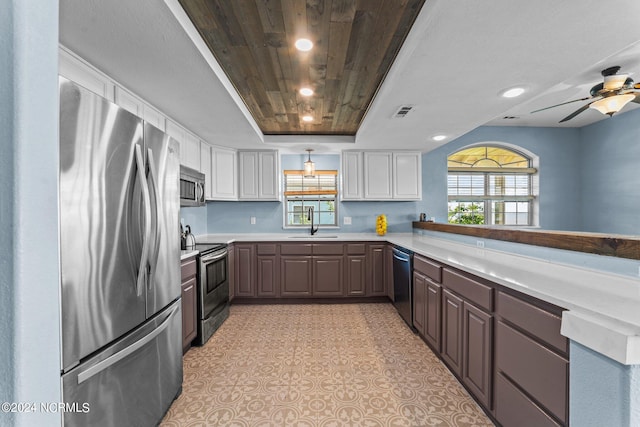 kitchen with white cabinetry, dark brown cabinets, ceiling fan, appliances with stainless steel finishes, and wood ceiling