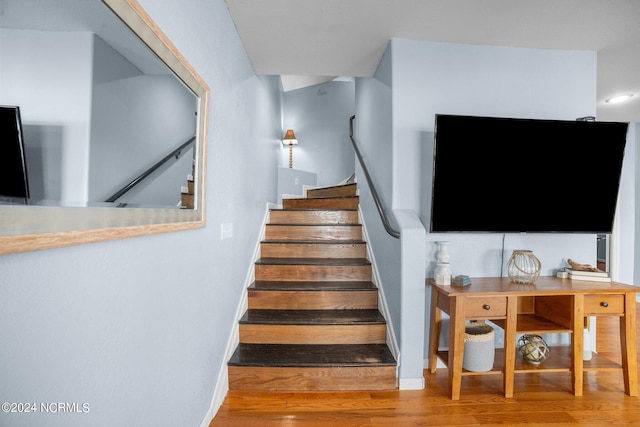 stairway featuring wood-type flooring