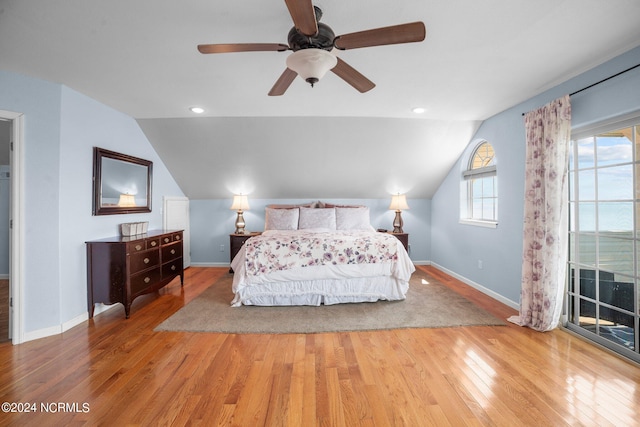 bedroom featuring lofted ceiling, light hardwood / wood-style flooring, and ceiling fan