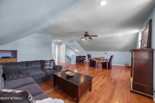 living room with lofted ceiling, a textured ceiling, ceiling fan, and wood-type flooring