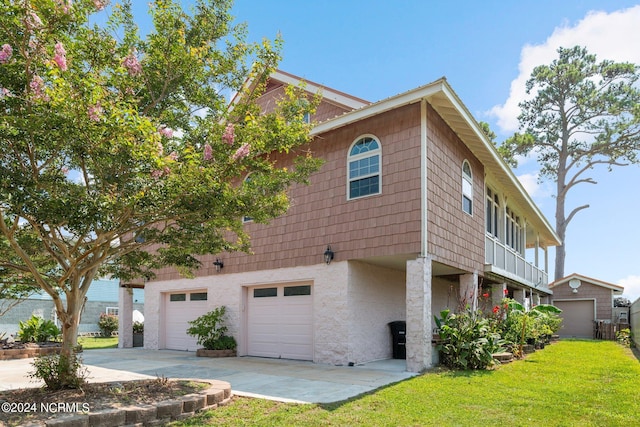 view of home's exterior with a garage and a yard