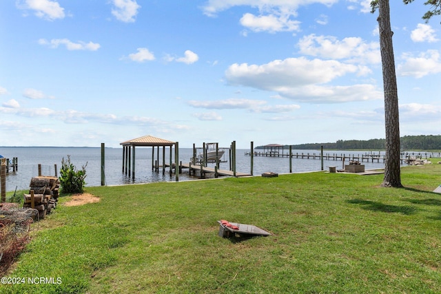 view of dock featuring a water view, a yard, and boat lift