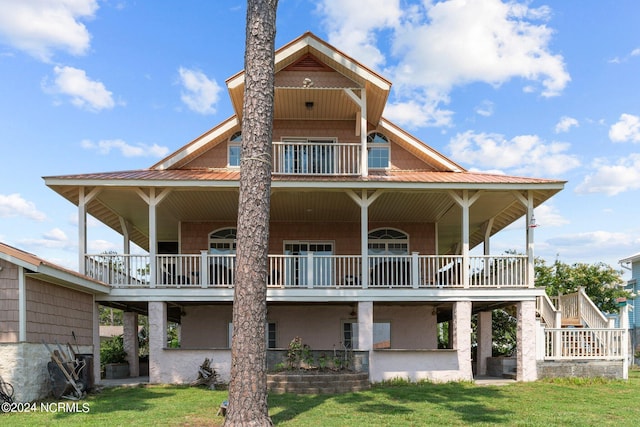 back of property with a balcony and a lawn