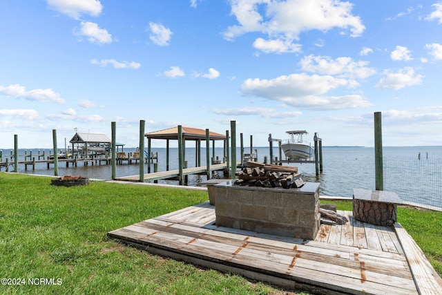 view of dock with a yard, a water view, and boat lift