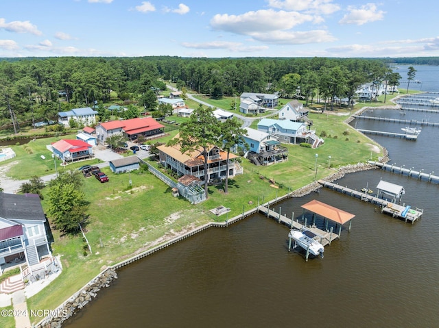 aerial view featuring a water view and a wooded view