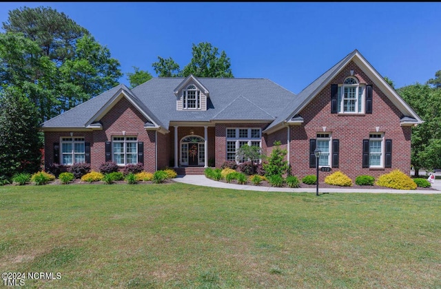 view of front of property with a front lawn and brick siding