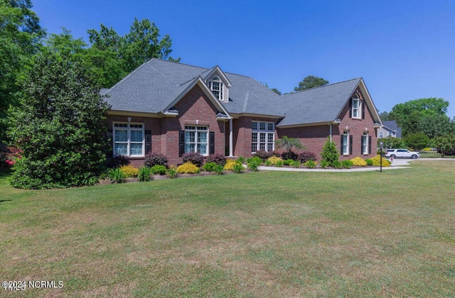 view of front of house featuring a front yard and brick siding