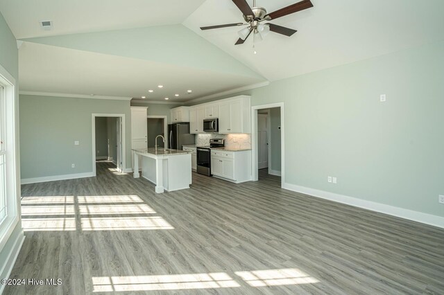 unfurnished living room featuring ceiling fan, crown molding, sink, high vaulted ceiling, and light hardwood / wood-style flooring