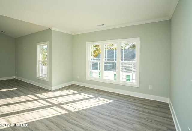 spare room with hardwood / wood-style floors and ornamental molding