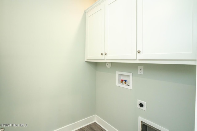 clothes washing area with hardwood / wood-style floors, hookup for a washing machine, cabinets, and hookup for an electric dryer