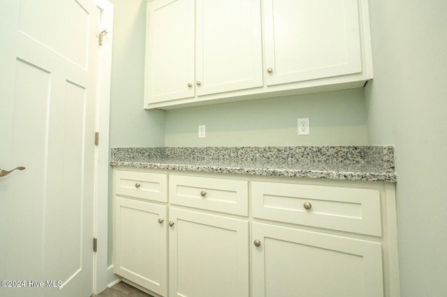 kitchen with white cabinets and light stone countertops