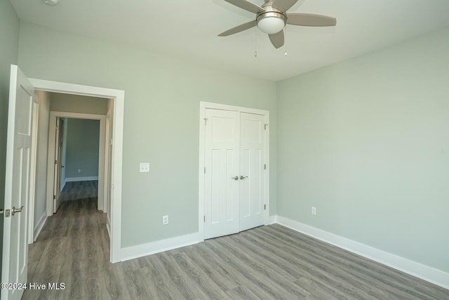 unfurnished bedroom with a closet, light hardwood / wood-style flooring, and ceiling fan