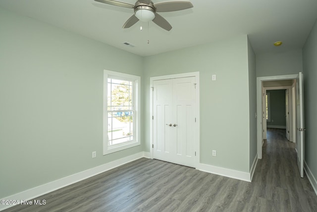 unfurnished bedroom featuring wood-type flooring, a closet, and ceiling fan