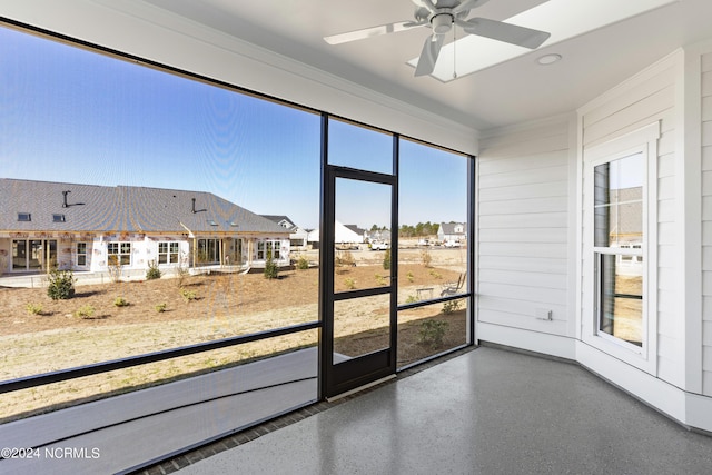 unfurnished sunroom with a ceiling fan