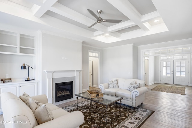 living room with crown molding, french doors, coffered ceiling, and light wood-style floors