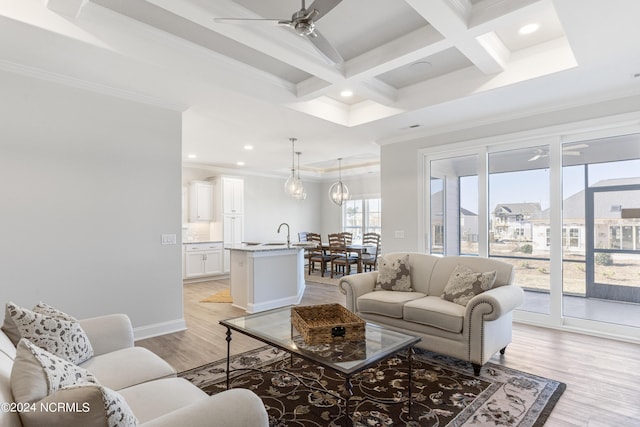 living room featuring beam ceiling, light wood finished floors, recessed lighting, ornamental molding, and coffered ceiling