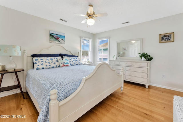 bedroom with light hardwood / wood-style flooring and ceiling fan