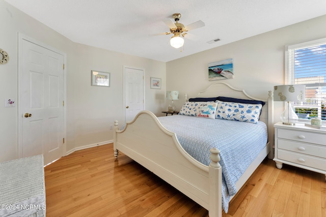 bedroom with light wood-type flooring and ceiling fan