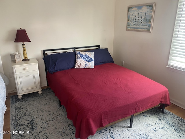 bedroom with hardwood / wood-style floors