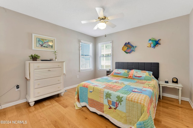 bedroom with ceiling fan and light hardwood / wood-style floors