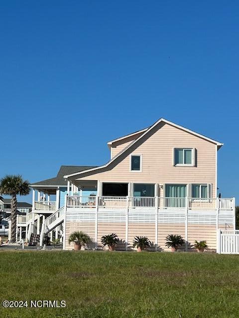 back of house with a lawn