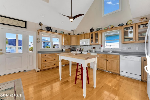 kitchen featuring white appliances, light hardwood / wood-style floors, high vaulted ceiling, and ceiling fan