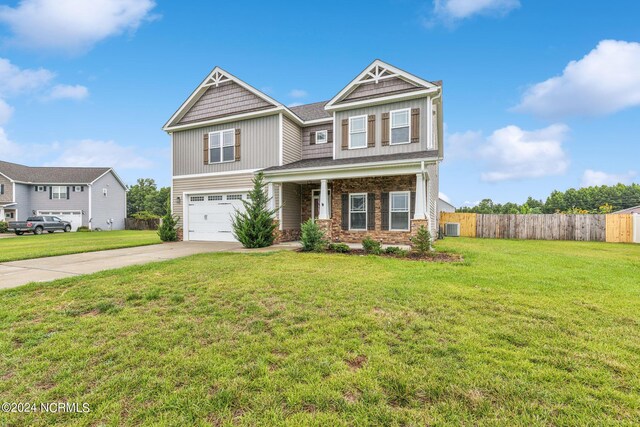 craftsman-style house with a garage and a front lawn