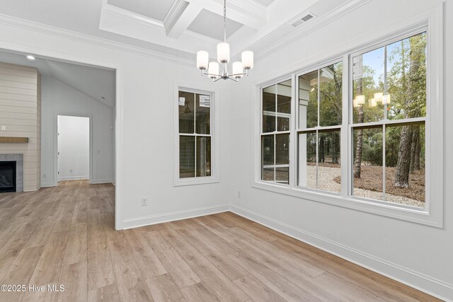 unfurnished dining area featuring a notable chandelier, a fireplace, visible vents, baseboards, and light wood-style floors