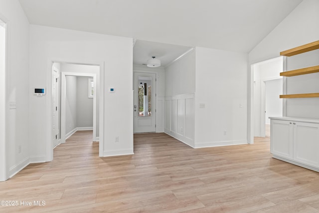 interior space featuring vaulted ceiling and light wood-style flooring