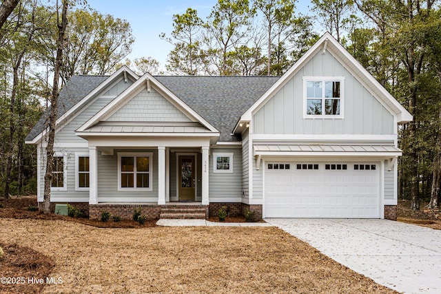 view of front of property featuring a standing seam roof, a shingled roof, board and batten siding, and concrete driveway