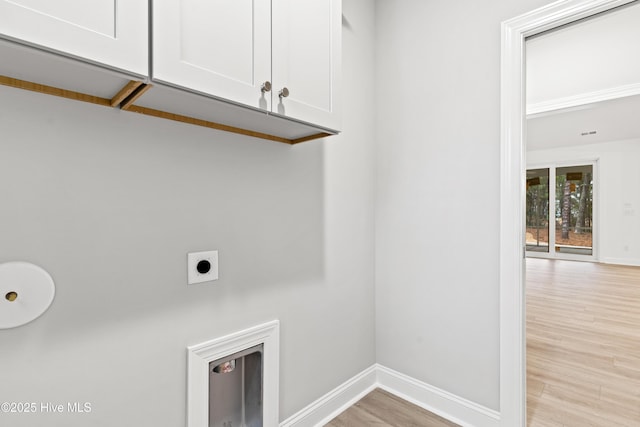 laundry room with baseboards, light wood-style floors, cabinet space, and hookup for an electric dryer